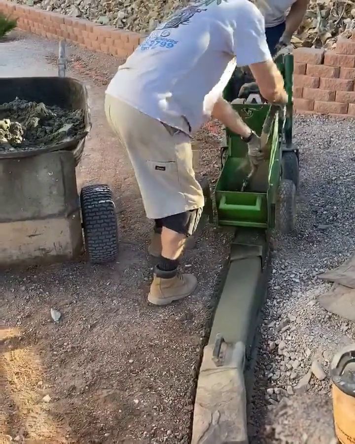 Our curbing machine extruding a stamped concrete curb