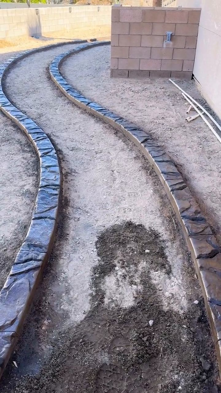 Stamped curb running along a walkway